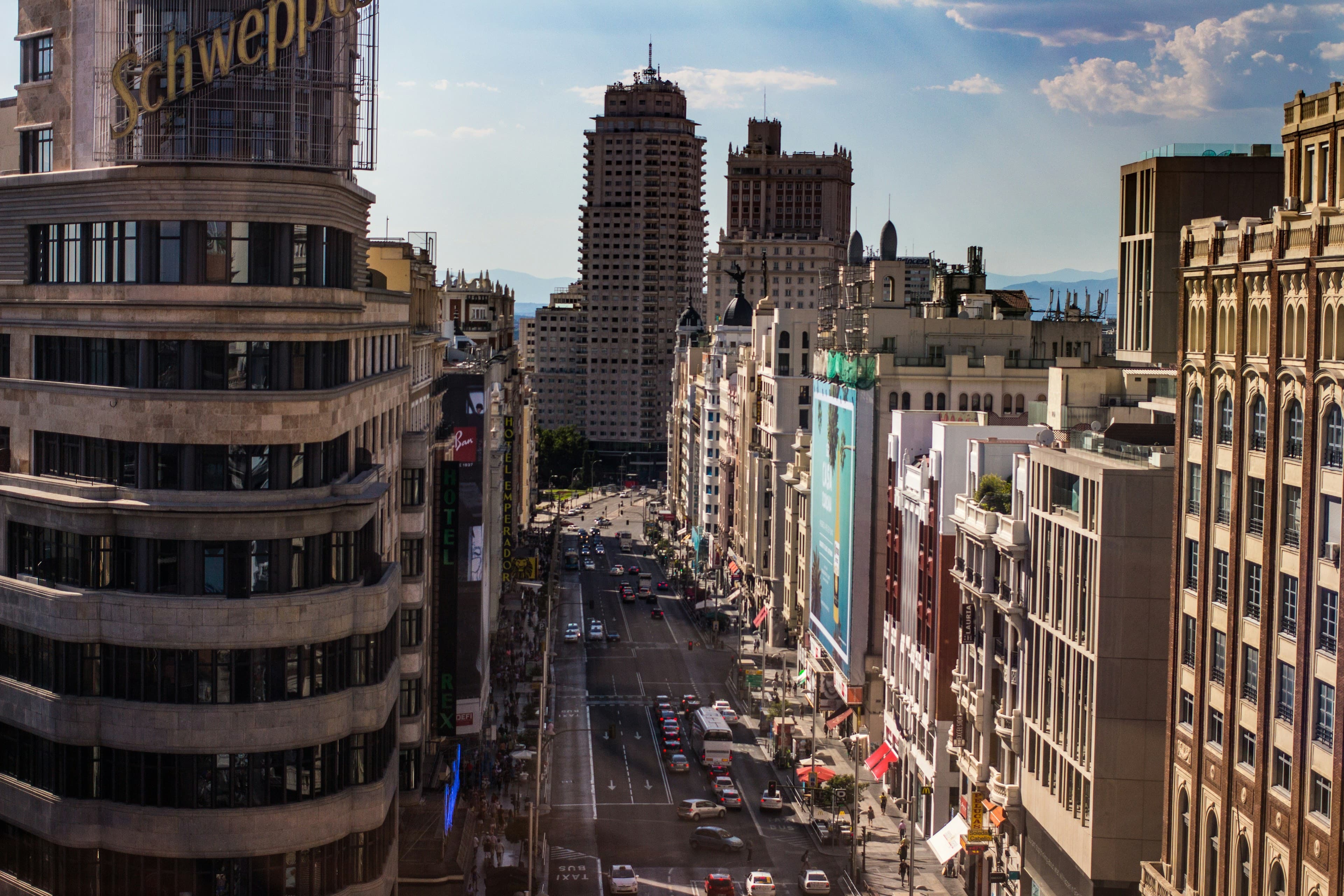 The view down Gran Vía in Madrid, the Carrión building and Edificio España framing the busy avenue in afternoon light.