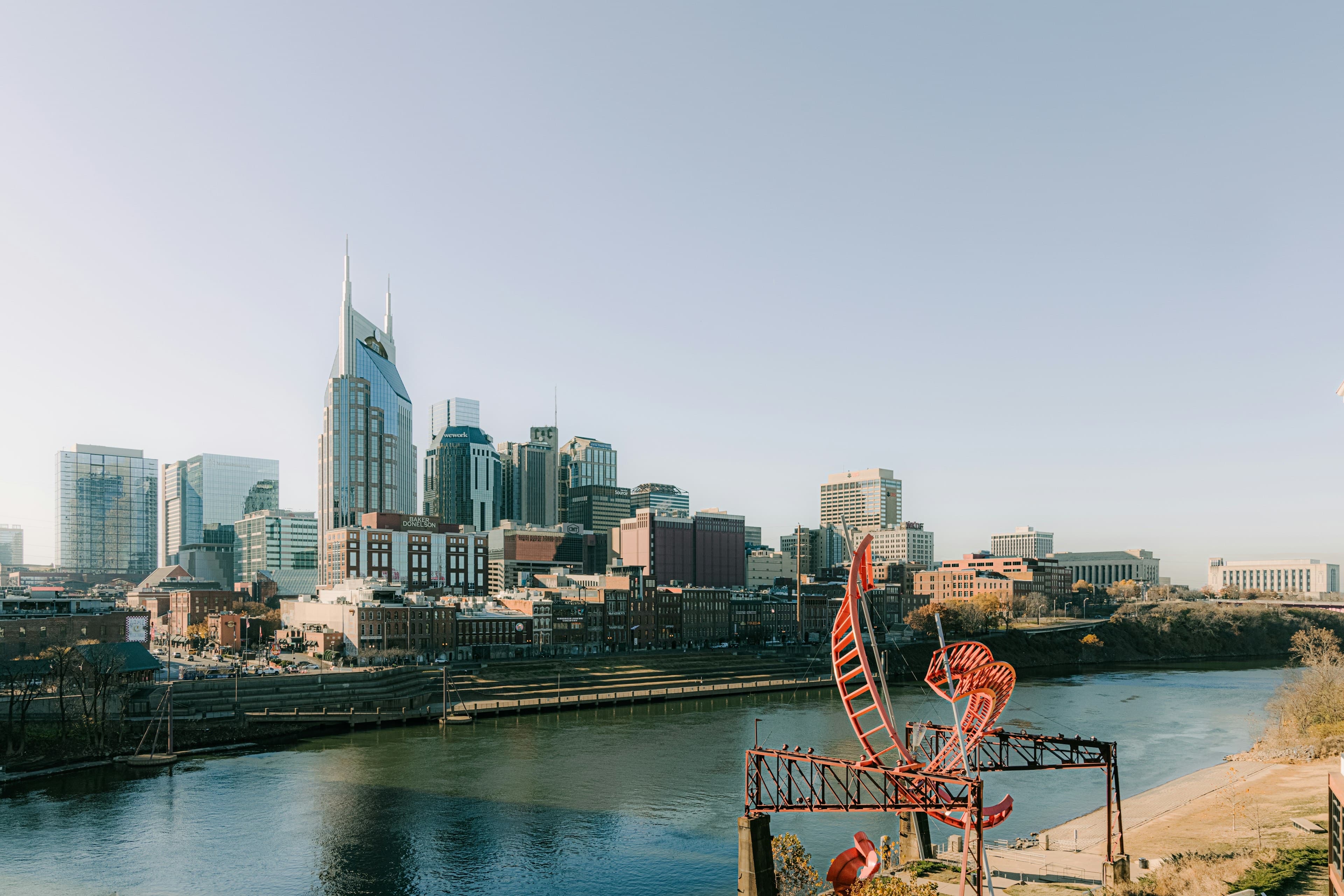 The downtown Nashville skyline along the Cumberland River, the pointed AT&T tower rising above the city.