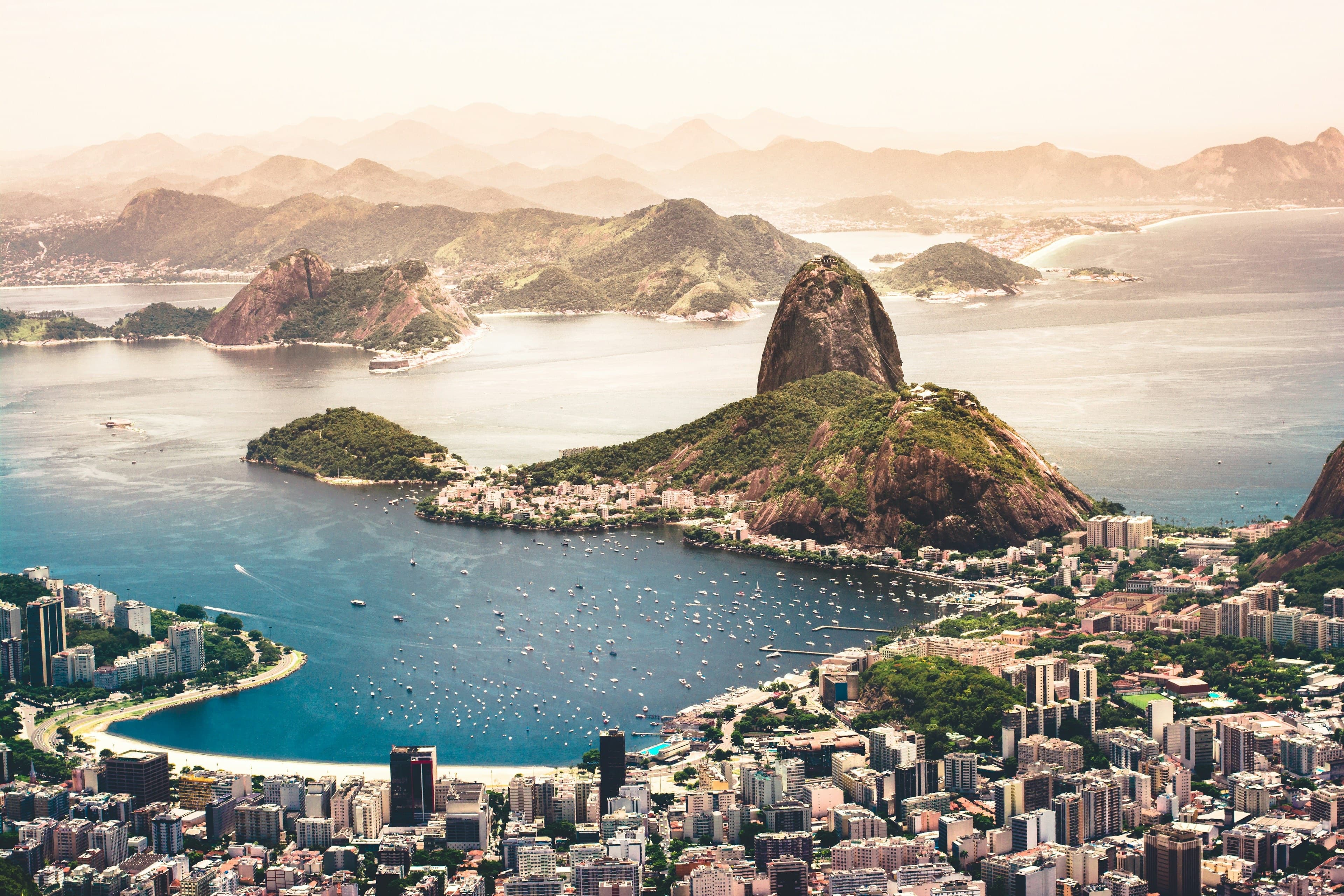 Rio de Janeiro from above Botafogo — Sugarloaf Mountain rising over the bay, boats moored below and the city spread along the shoreline.